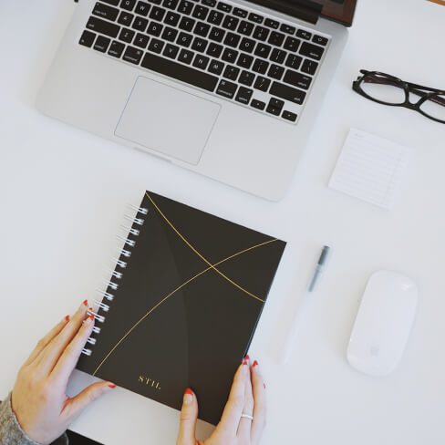 The discussion guide in front of a laptop while preparing for a user interview.