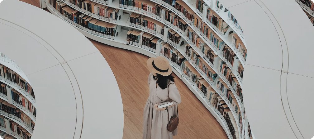 A woman in a library holding a book