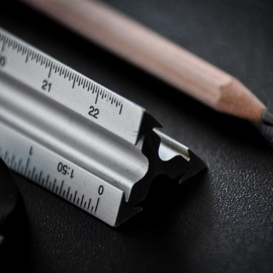 Ruler and pencil on black table