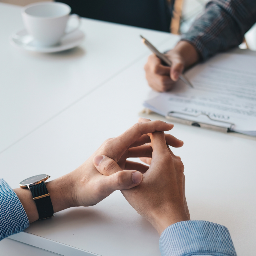 A person holding a crossed fingers and participating in a user interview