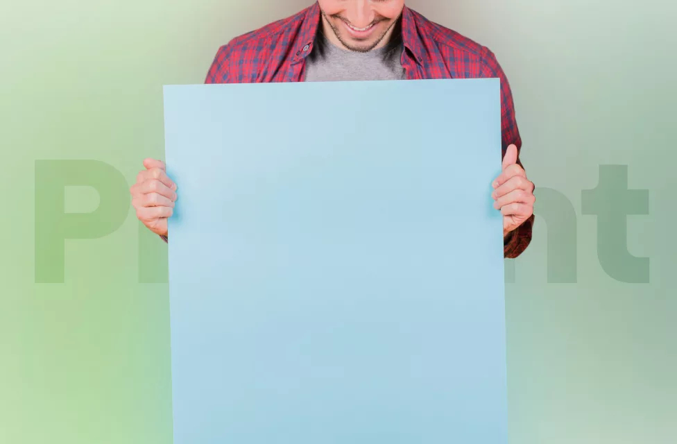 Man in red shirt holding a blue paper